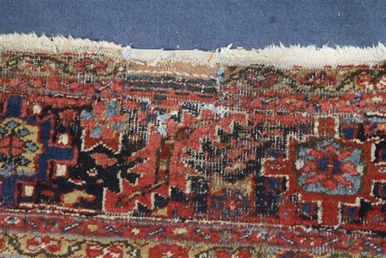A Persian Heriz red ground carpet, 380 x 280cm, worn
